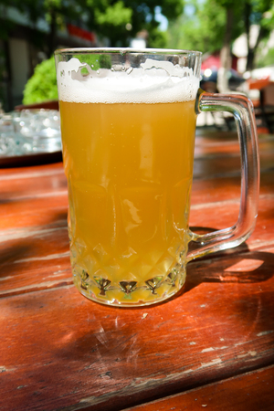 A beer mug in the summer bar on the tableの写真素材