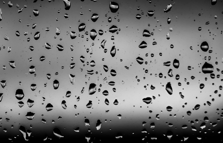 Water drops after the rain in a dark windowの写真素材