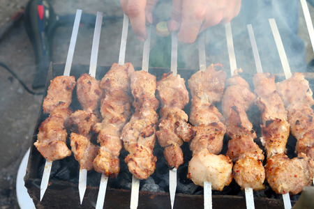 Meat on skewers skewers are cooked on charcoalの写真素材