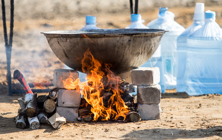 Large cauldron on fire, prepare food