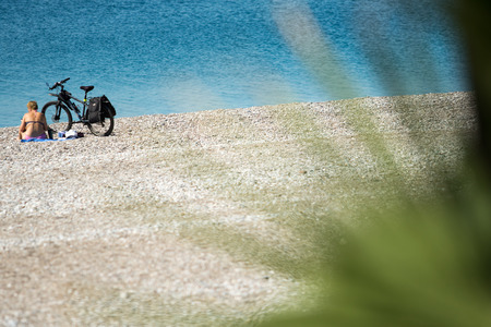 Palm trees in focus, blurred beach backgroundの写真素材