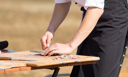 Cut and clean the fish in gloves, defocusedの写真素材