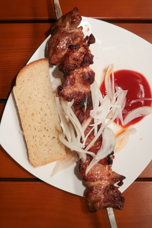 Meat on a stick shish kebab with bread, foodの写真素材