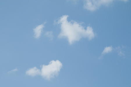 White fluffy clouds on a blue sky, wallpaperの写真素材