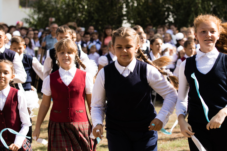 Petropavlovsk, Kazakhstan - September 2, 2017: School line is in schoolyard with pupils and teachers. Children go back to school. The Knowledge Day in Kazakhstan first day of school.のeditorial素材