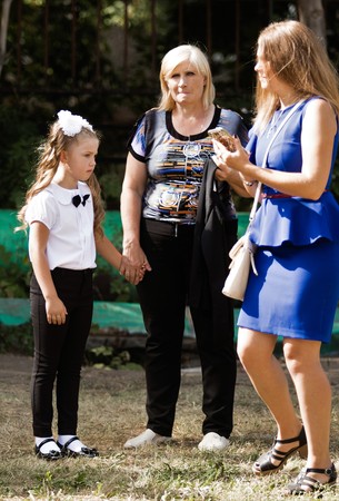 Petropavlovsk, Kazakhstan - September 2, 2017: School line is in schoolyard with pupils and teachers. Children go back to school. The Knowledge Day in Kazakhstan first day of school.のeditorial素材