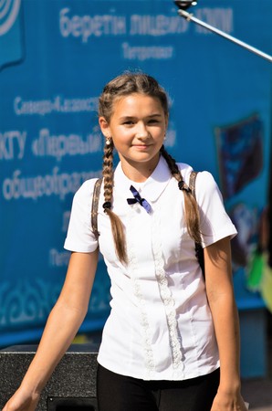 Petropavlovsk, Kazakhstan - September 2, 2017: School line is in schoolyard with pupils and teachers. Children go back to school. The Knowledge Day in Kazakhstan first day of school.のeditorial素材