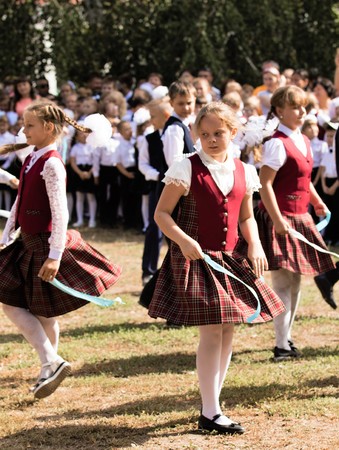 Petropavlovsk, Kazakhstan - September 2, 2017: School line is in schoolyard with pupils and teachers. Children go back to school. The Knowledge Day in Kazakhstan first day of school.のeditorial素材