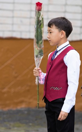 Petropavlovsk, Kazakhstan - September 2, 2017: School line is in schoolyard with pupils and teachers. Children go back to school. The Knowledge Day in Kazakhstan first day of school.のeditorial素材