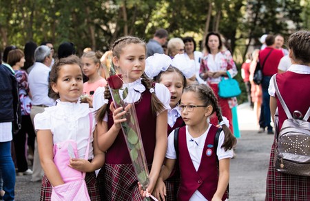 Petropavlovsk, Kazakhstan - September 2, 2017: School line is in schoolyard with pupils and teachers. Children go back to school. The Knowledge Day in Kazakhstan first day of school.のeditorial素材