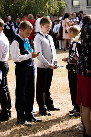 Petropavlovsk, Kazakhstan - September 2, 2017: School line is in schoolyard with pupils and teachers. Children go back to school. The Knowledge Day in Kazakhstan first day of school.のeditorial素材