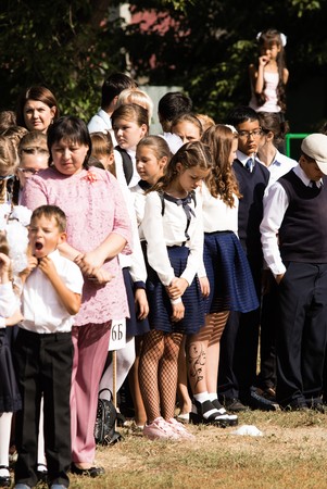 Petropavlovsk, Kazakhstan - September 2, 2017: School line is in schoolyard with pupils and teachers. Children go back to school. The Knowledge Day in Kazakhstan first day of school.のeditorial素材