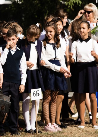 Petropavlovsk, Kazakhstan - September 2, 2017: School line is in schoolyard with pupils and teachers. Children go back to school. The Knowledge Day in Kazakhstan first day of school.のeditorial素材