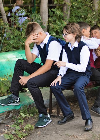 Petropavlovsk, Kazakhstan - September 2, 2017: School line is in schoolyard with pupils and teachers. Children go back to school. The Knowledge Day in Kazakhstan first day of school.のeditorial素材