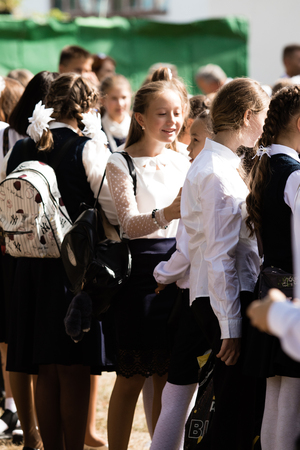 Petropavlovsk, Kazakhstan - September 2, 2017: School line is in schoolyard with pupils and teachers. Children go back to school. The Knowledge Day in Kazakhstan first day of school.のeditorial素材