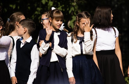 Petropavlovsk, Kazakhstan - September 2, 2017: School line is in schoolyard with pupils and teachers. Children go back to school. The Knowledge Day in Kazakhstan first day of school.のeditorial素材