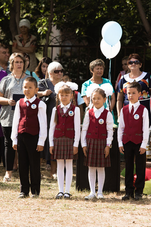 Petropavlovsk, Kazakhstan - September 2, 2017: School line is in schoolyard with pupils and teachers. Children go back to school. The Knowledge Day in Kazakhstan first day of school.のeditorial素材