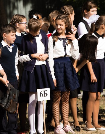 Petropavlovsk, Kazakhstan - September 2, 2017: School line is in schoolyard with pupils and teachers. Children go back to school. The Knowledge Day in Kazakhstan first day of school.のeditorial素材