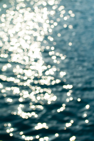 glare bokeh on the water of the seaの写真素材