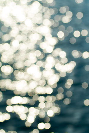 glare bokeh on the water of the seaの写真素材