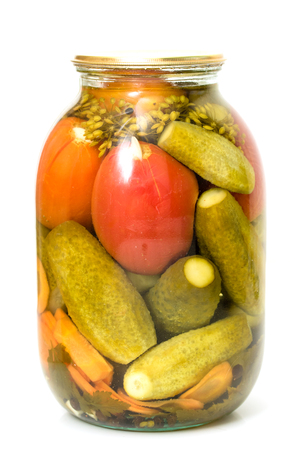 Pickled cucumbers with tomatoes in a glass jarの写真素材
