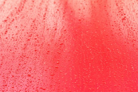 raindrops on a red wallの写真素材