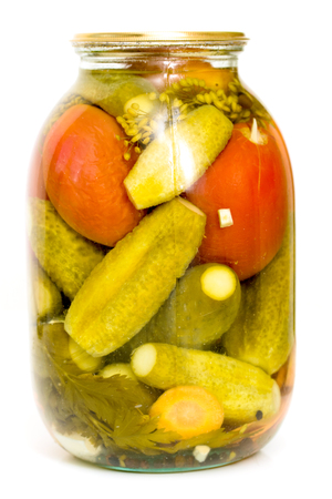 Pickled cucumbers with tomatoes in a glass jarの写真素材