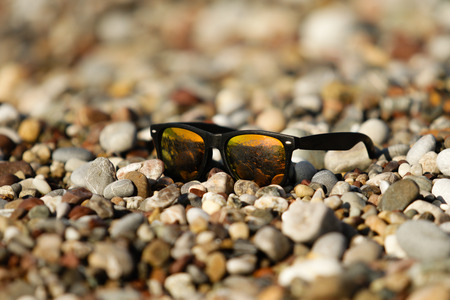 glasses in the sand on the beachの写真素材