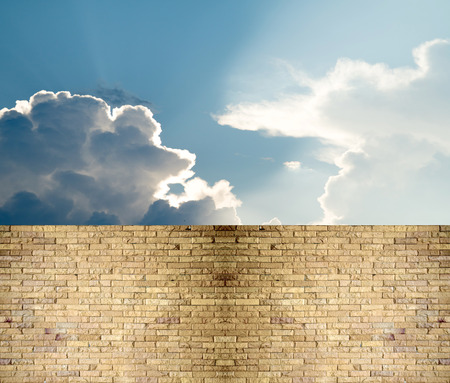 sky clouds over stone fenceの写真素材