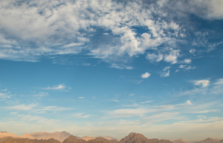 Cirrus clouds on blue sky and mountainsの写真素材