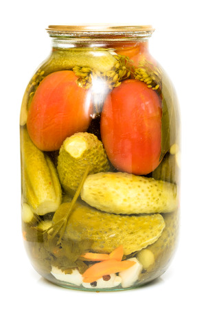 Pickled cucumbers with tomatoes in a glass jarの写真素材