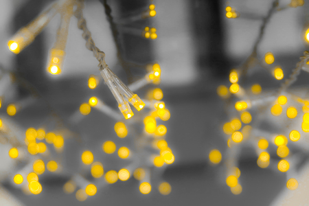 bokeh yellow lights garland backgroundの写真素材