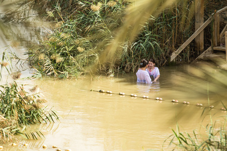 JERICHO, ISRAEL - NOVEMBER 14. 2017: Pilgrims and tourists on Jordan River in Qasr el Yahud.