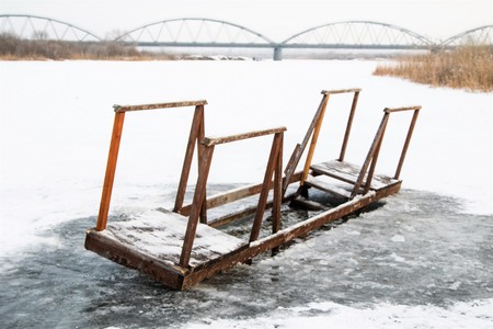 wooden bridge in the snowの写真素材