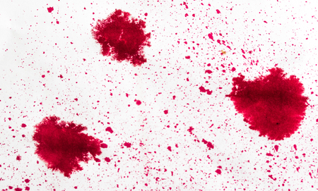 small splashes of red paint on white backgroundの写真素材