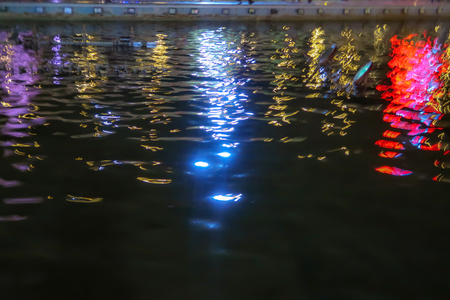reflection of bright lights in the night waterの写真素材