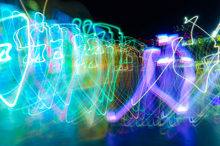 blurred lights in motion on a black backgroundの写真素材