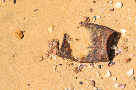 old metal debris on the sandの写真素材