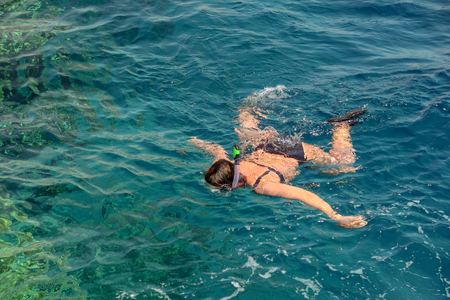 girls swim in the sea with a maskの写真素材