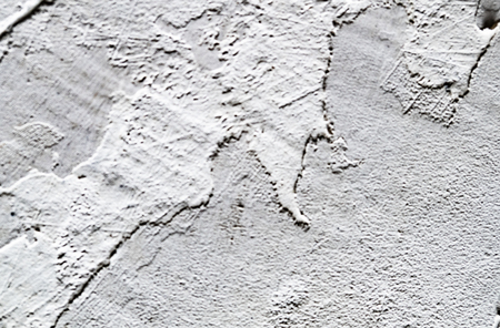 old concrete wall of white grunge plasterの写真素材