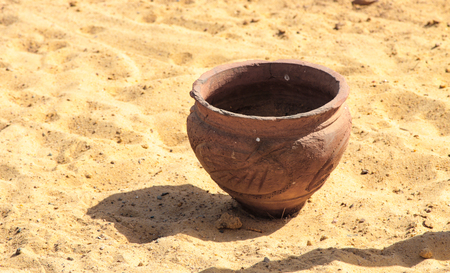 clay jug on the beach for rubbishの写真素材