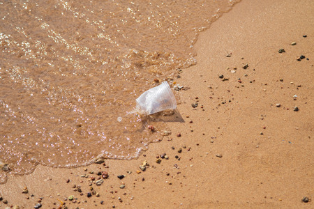 plastic trash on the sandy beachの写真素材