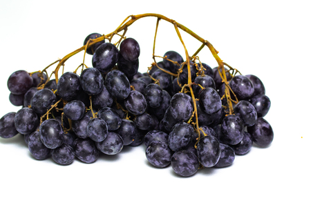a bunch of dark grapes isolated on white background