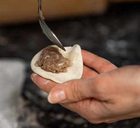 Homemade dumplings from dough and minced meat, preparation  ravioli, with minced meat close up.の写真素材