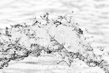 splashes of water drops on a white bokeh backgroundの写真素材