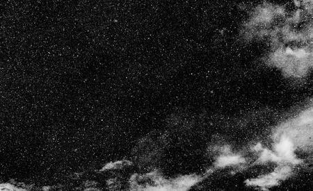 snow, stars, white dots bokeh on black backgroundの写真素材