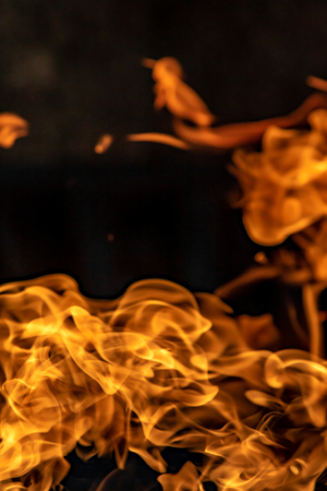 Fire flames on black background, abstract blaze.の写真素材