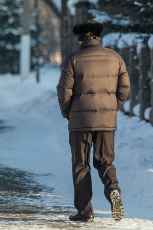 man walking in the snow, rear viewの写真素材