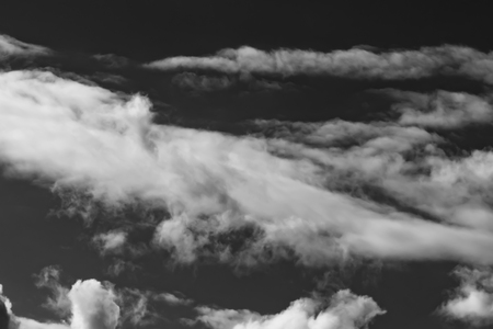 white clouds on a dark sky, monochromeの写真素材