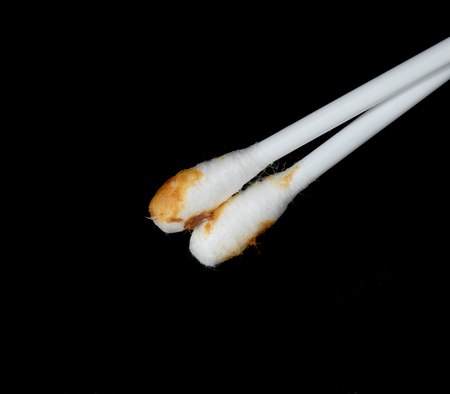 white ear sticks used on a black backgroundの写真素材